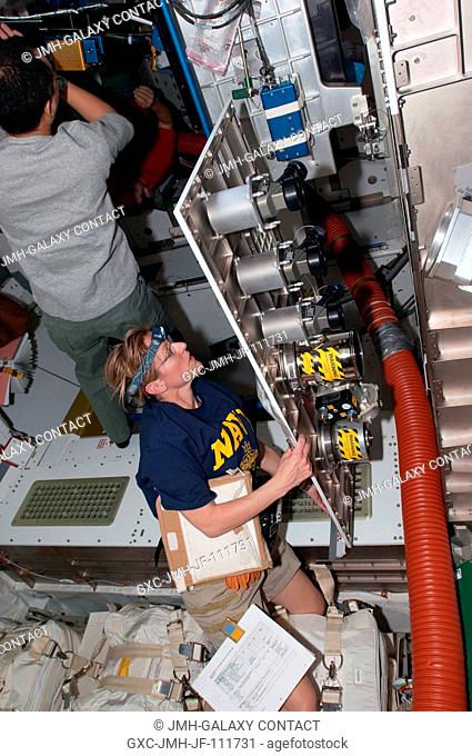 NASA astronaut Kathryn Hire, STS-130 mission specialist, works with hardware in the newly-installed Tranquility node of the International Space Station while...