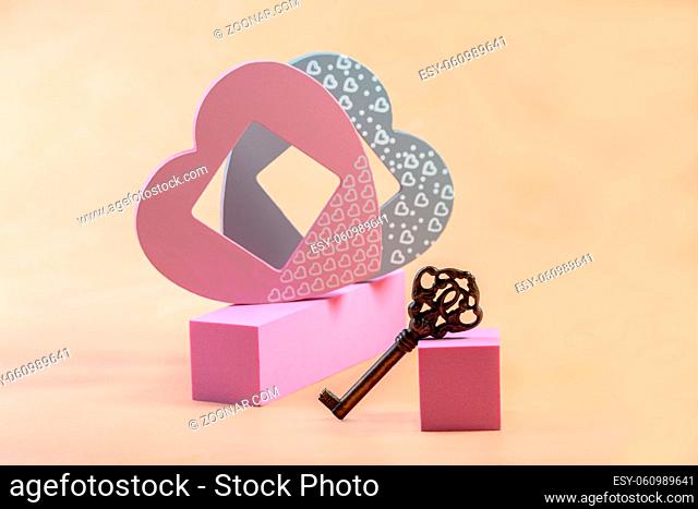 Podium presentation background with heart-shaped decoration and vintage key. Concept of a Valentine's Day greeting. Copy space