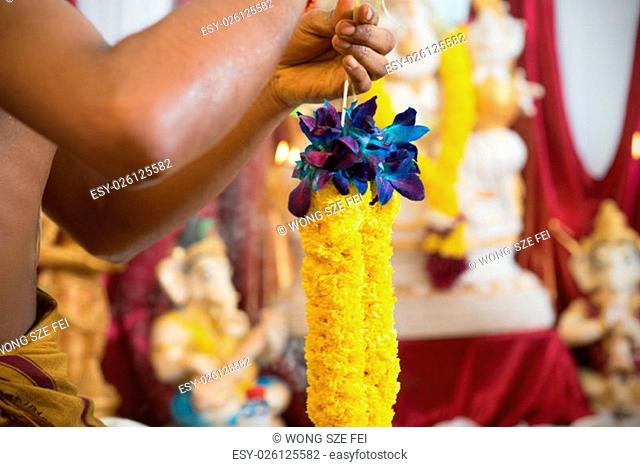Tie up flower garland. Traditional Indian Hindus ear piercing ceremony. India special rituals