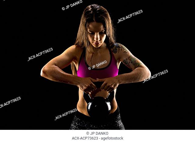 Female athlete with kettle bell working out