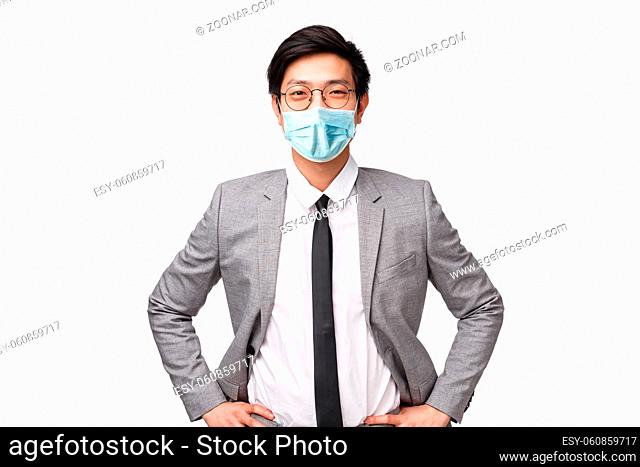 Lets earn some money. Handsome confident and smart asian businessman in suit and tie, standing in ready, determined pose, smiling upbeat