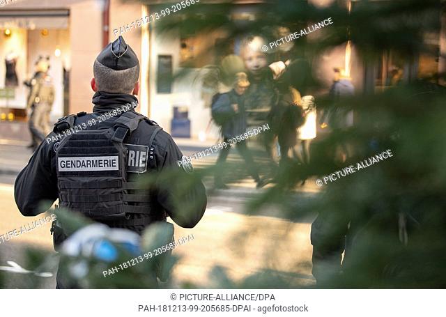 13 December 2018, France (France), Straßburg: A policeman is standing in the city centre after an attack in the area of the Strasbourg Christmas market
