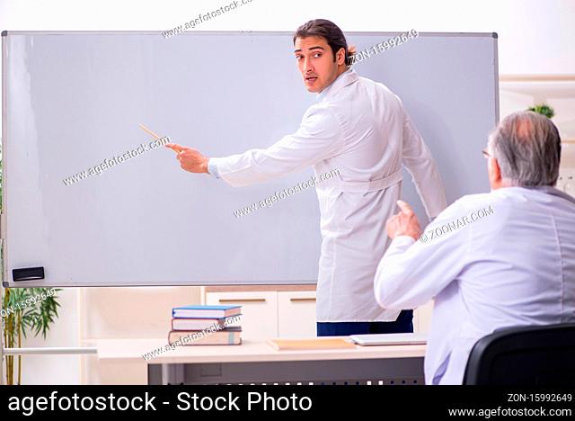 Experienced doctor teaching young assistant