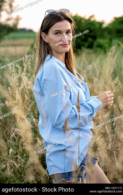 young woman enjoys the summer in the country, franconia, bavaria, germany