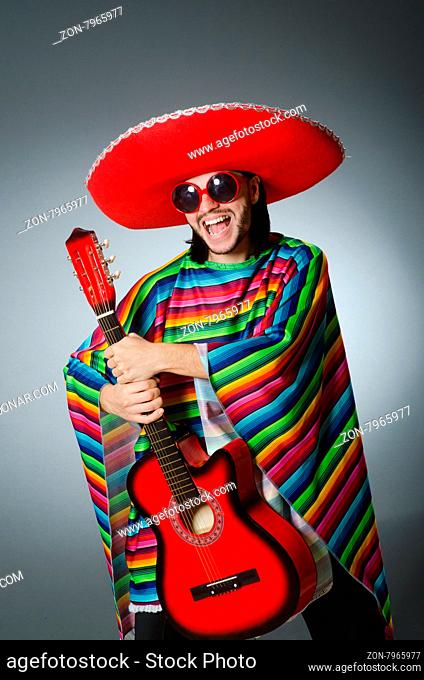 Mexican playing guitar wearing sombrero