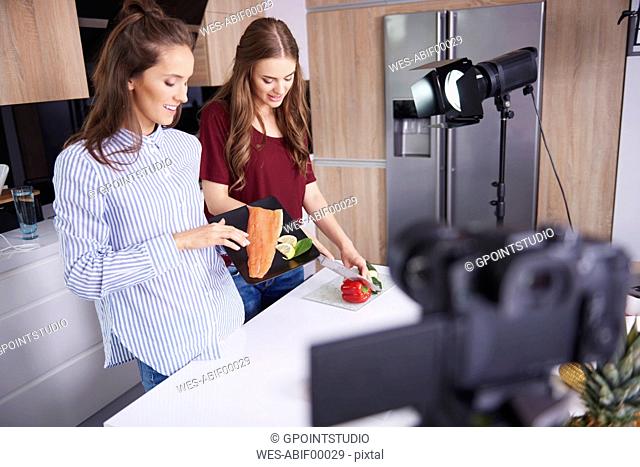 Camera filming bloggers while cooking