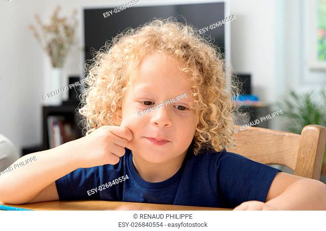 a portrait of a little boy with blond curly hair
