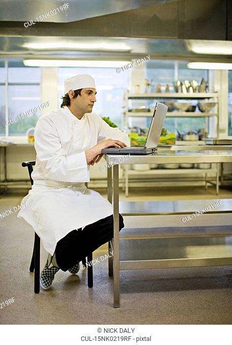 A chef working at his laptop