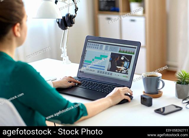 woman with video editor program on laptop at home