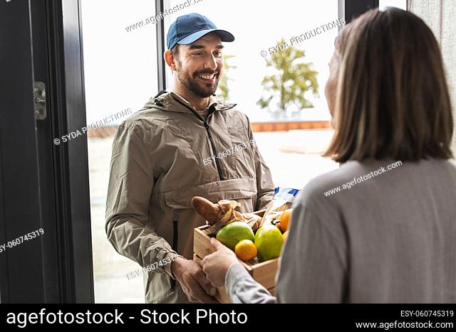 food delivery man giving order to female customer