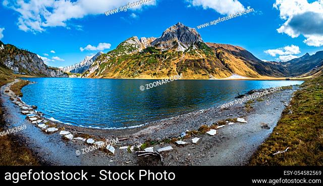 Sunny autumn alpine Tappenkarsee lake and rocky mountains above, Kleinarl, Land Salzburg, Austria. Picturesque hiking, seasonal, and nature beauty concept scene