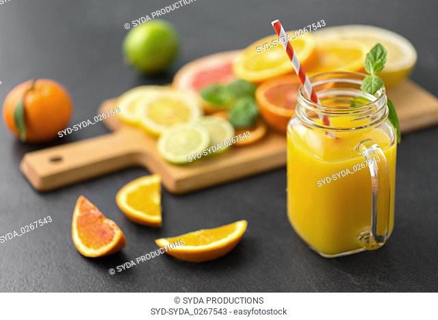 mason jar glass of fruit juice on slate table top