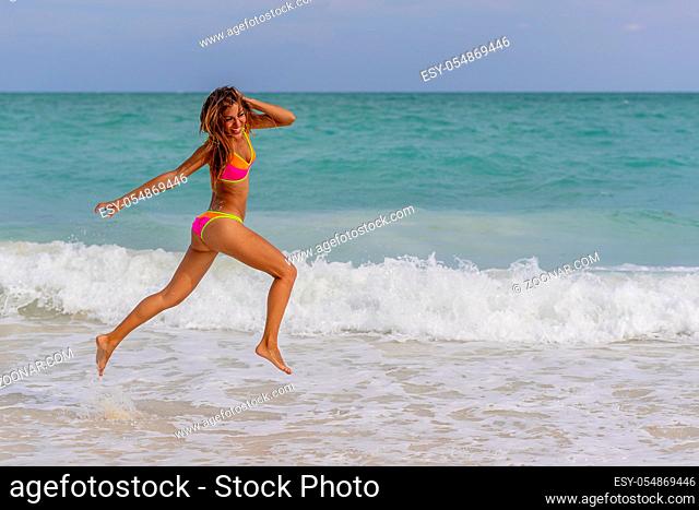 A beautiful hispanic brunette model enjoying a day at the beach