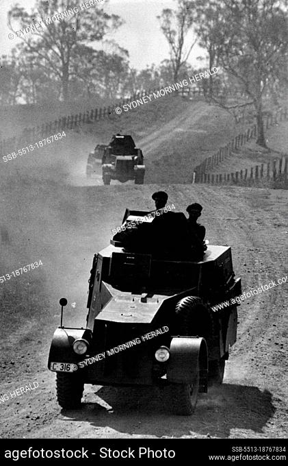 War exercises in peaceful country lanes. Three units of Australia's 2nd Armored Car Regiment, in training near Dapto, moving towards near Dapto