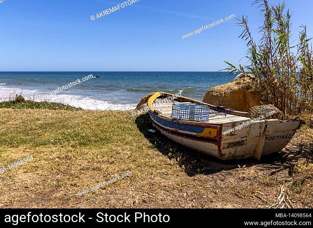portugal, wooden boat on the beach in the algarve
