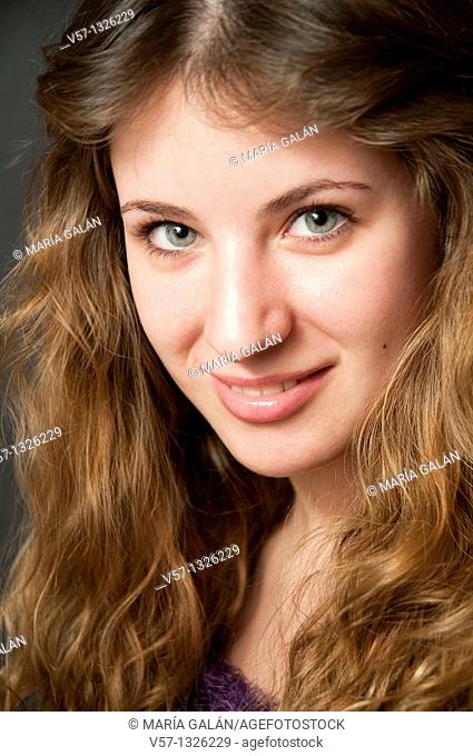 Portrait of young woman smiling and looking at the camera. Close view