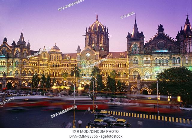 Traffic at illuminated Victoria Terminus VT now Chhatrapati Shivaji Terminus CST railway station , Bombay Mumbai , Maharashtra , India