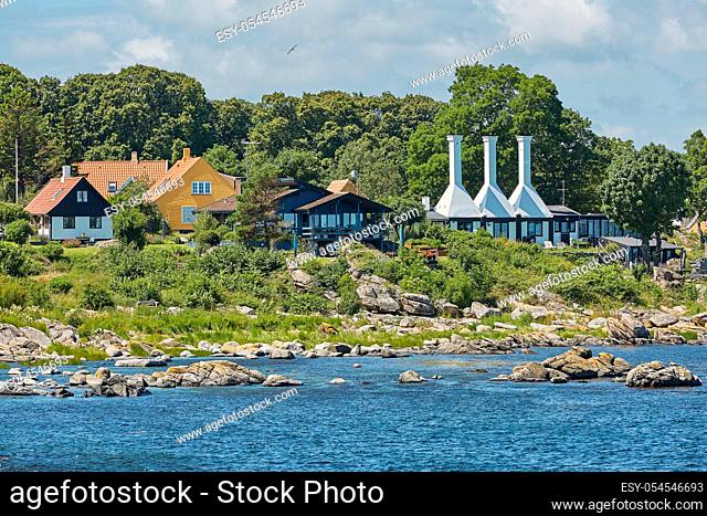 The roofs and chimneys of very small smoke houses so typical and famous for small village of Svaneke on Bornholm island in Denmark