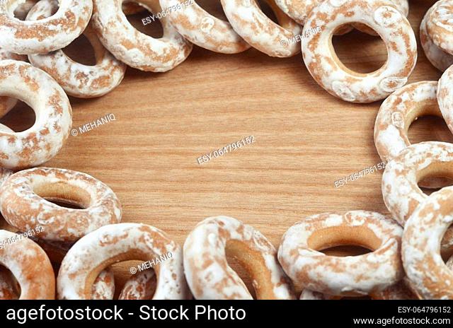 Background image of a variety of glazed donuts, which lie on a wooden table with space for text or any content