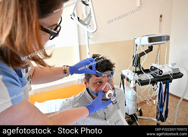 Head nurse Dana Dvorackova, left, helps a patient during an examination in the sleep laboratory of the University Hospital in Brno, March 17, 2023