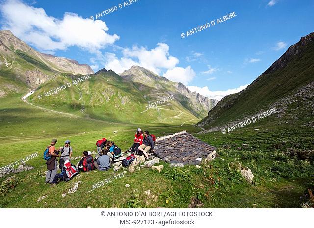 A group of hikers have a rest in Formazza Valley nearby and old farmer hut  lepontine alps  Verbano Cusio Ossola province  piemonte  italy  europe