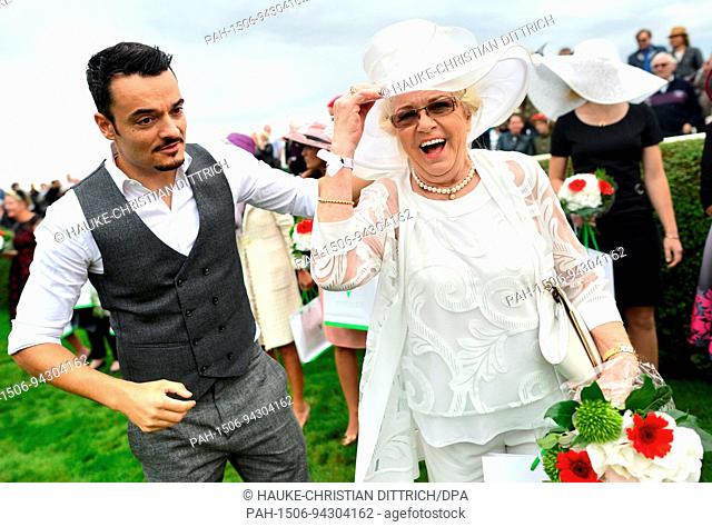 Musician Giovanni Zarrella and a woman that participates at the Lady Elegance competition at the Ascot horse race day in Hanover (Germany), 20 August 2017