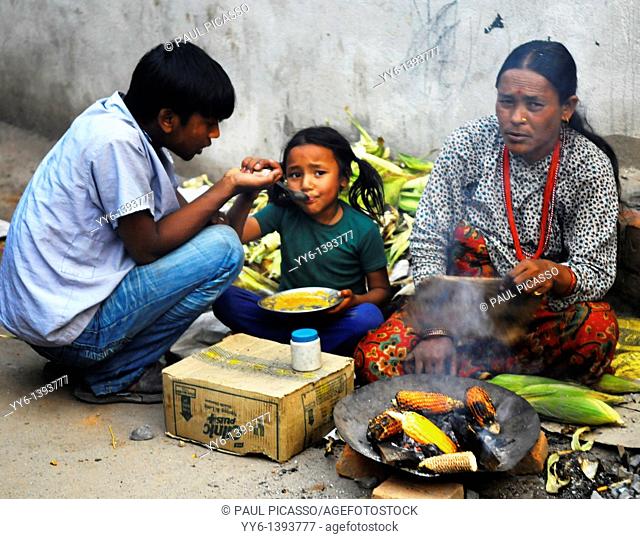 nepalese family selling corn on the cob to survive , the nepalis , life in kathmandu , kathmandu street life , nepal