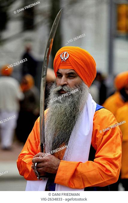 A Sikh Holy One holds a sword during the Khalsa Day Parade celebrating Vaisakhi in Toronto, Canada. Vaisakhi is one of the most significant holidays in the Sikh...