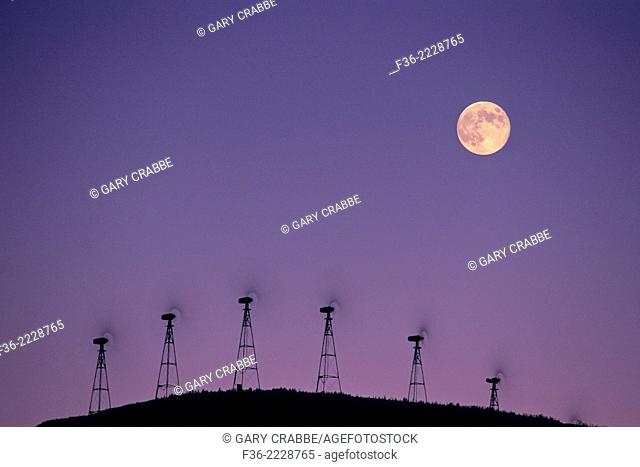 Moon over wind turbine clean energy windmills, Altamont Pass, Alameda County, California