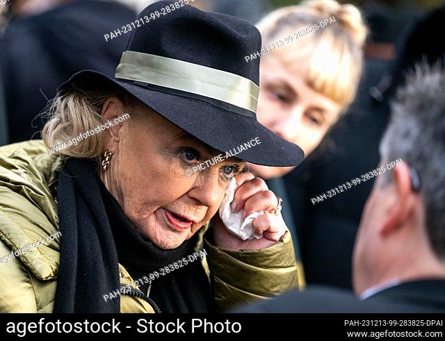13 December 2023, Saxony, Chemnitz: Gabriele ""Gaby"" Seyfert, daughter of Jutta Müller, wipes a tear from her face at the funeral service for figure skating...