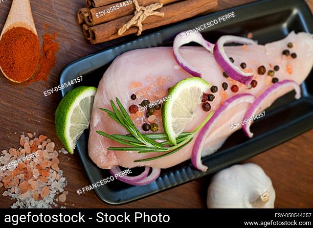 fresh organic chicken breast with herbs and spices
