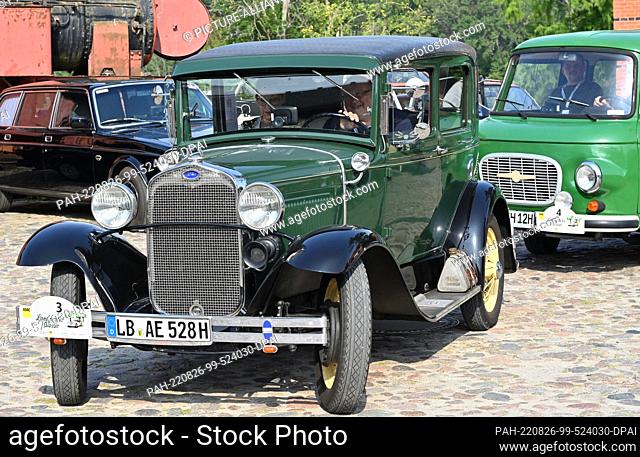 26 August 2022, Brandenburg, Nauen: A Ford Model A Tudor (built in 1928 with a 40 hp, 3.3 liter engine) drives to the start of the ADAC Landpartie Classic at...
