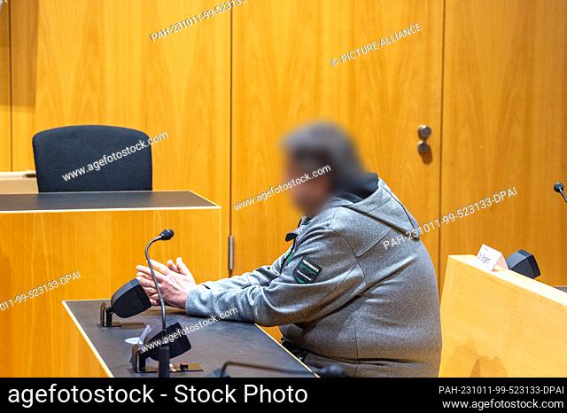 11 October 2023, Bavaria, Augsburg: A man sits in the dock at the regional court. The defendant allegedly drove at almost three times the speed limit in an area...