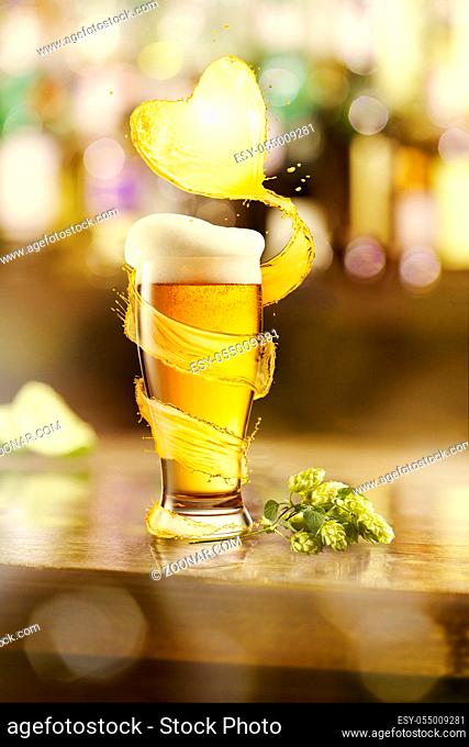 Creative composition from glass mug of cold fresh light beer with spiral splash around and big heart shape from beer beverage on a blurred pub background