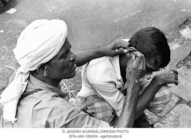 Man ear cleaner Mohammed Ali road Mumbai Maharashtra India Asia 1976