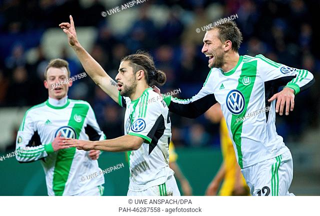 Wolfsburg's Ricardo Rodriguez (C) celebrates the 1-2 goal with Bas Dost (R) and Maximilian Arnold during the DFB Cup quarter final match between 1899 Hoffenheim...