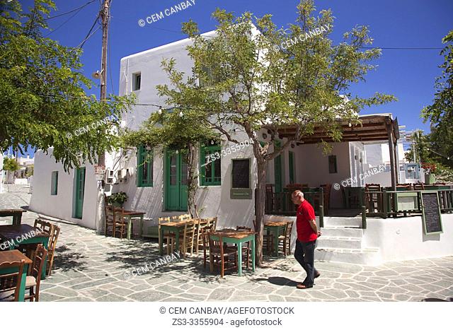 Man walking in front of the traditional houses at the town center Chora, Folegandros, Cyclades Islands, Greek Islands, Greece, Europe