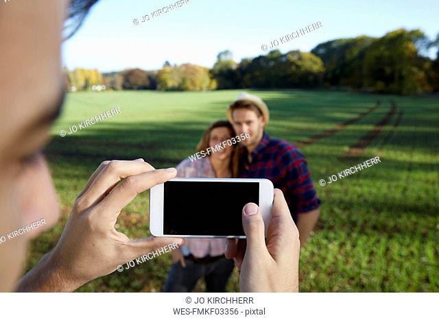 Cell phone picture of couple in the countryside