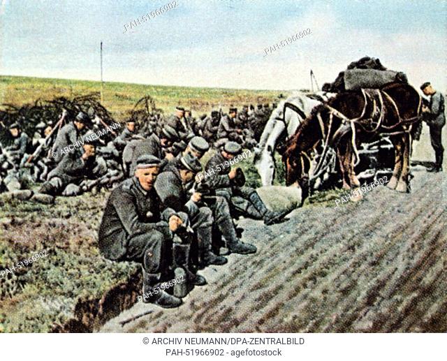The contemporary colorized German propaganda photo shows German infantry during a break in the marching to the Western Front