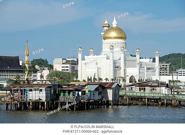 View towards mosque across shacks on stilts in river, Sultan Omar Ali Saifuddien Mosque, Water Village (Kampong Ayer), Brunei River, Bandar Seri Begawan, Brunei