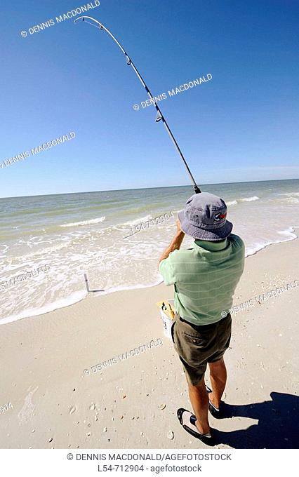 Senior man fishing for recreation in the Gulf of Mexico at Naples Florida