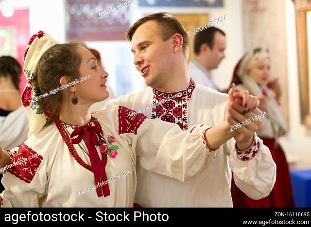 Belarus, the city of Gomiel on November 26, 2016.A couple in national dress is dancing at folk dances. A man and a woman in an embroidered shirt are dancing