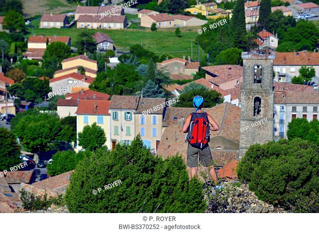 hiker over the church of Les Mees, France, Provence, Alpes de Haute Provence, Les Mees