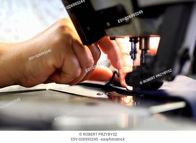 the production plant, sewing clothes by seamstresses on the sewing machine