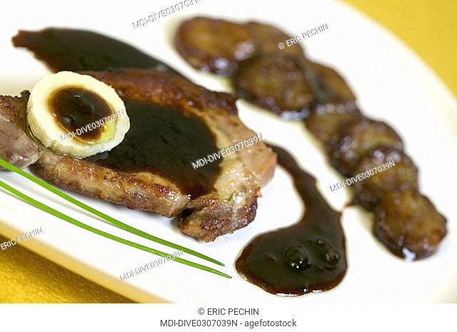 Grilled pork cutlet, roasted banana with a mulberry cream sauce
