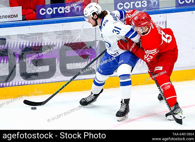 RUSSIA, MOSCOW - NOVEMBER 14, 2023: Dynamo's Vladislav Mikhailov (L) and Spartak's Shane Prince are in action in a 2023/24 KHL Regular Season ice hockey match...