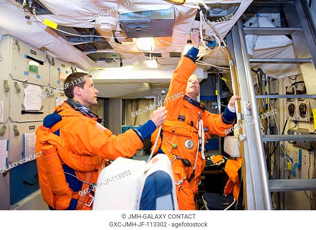 Astronauts Tom Marshburn (left) and Tim Kopra, both STS-127 mission specialists, attired in training versions of their shuttle launch and entry suits