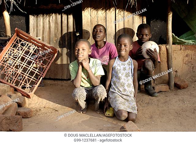Zimbabwe, Mashonaland Central, Kartu Village. May 2010. Four children, orphans, pose for a portrait at GodKnows Orphanage Supporting Scheme