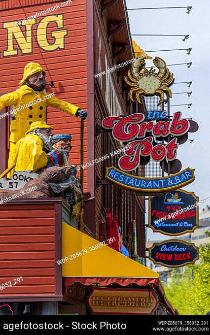 Statues and neon signs at the Crab Pot Restaurant and Bar on the waterfront in Seattle, Washington State, USA