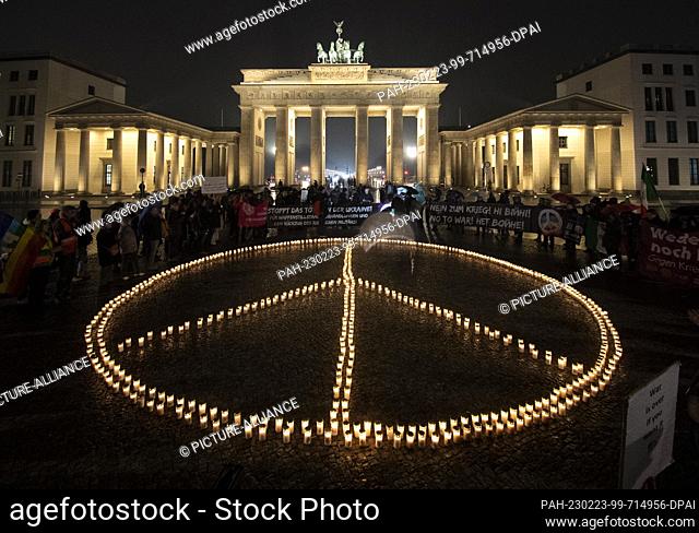 dpatop - 23 February 2023, Berlin: To mark the anniversary of Russia's war of aggression on Ukraine, activists placed an oversized peace sign made of candles in...